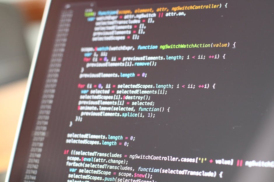 Close-up view of a modern laptop computer screen displaying lines of programming code, with the code editor open showing a project written in a language such as JavaScript or Java. The screen features
